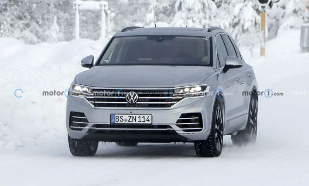 Volkswagen Touareg prototype hides its new style with stickers in new spy images